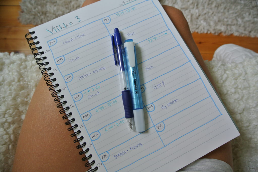 Hand written Fresh Body Fit Mind planner on a white notebook