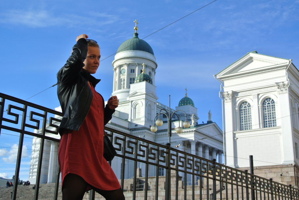 Beautiful Helsinki A girl standing in front of the Beautiful Helsinki Senate Square church in the sunshine against blue sky