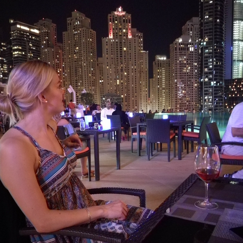 Dubai by night Dubai Marina hotel Address restaurant with a glass of wine