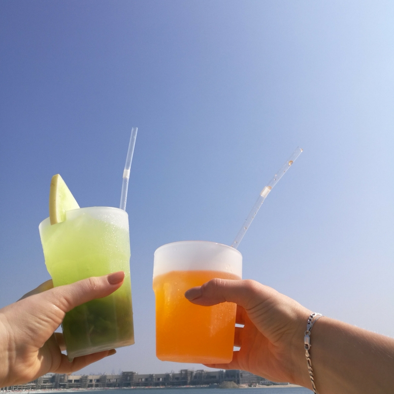 Layover in Dubai Colorful cocktails green and orange drinks blue sky