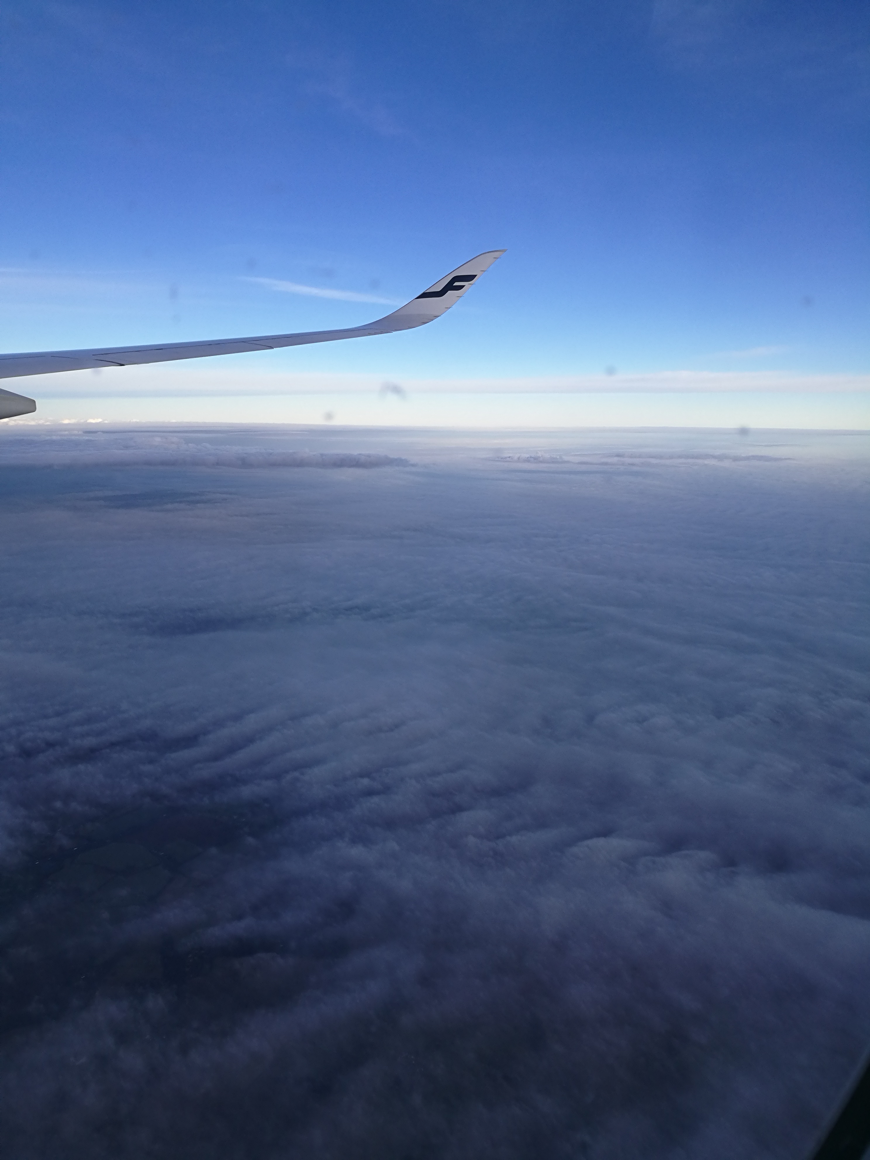 A few things about flying A view from the window of a Finnair airplane above the clouds