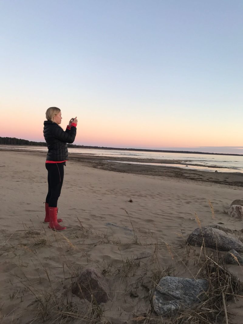 Sunset drive A blonde girl taking pictures of the sunset in Varessäikkä beach in Siikajoki