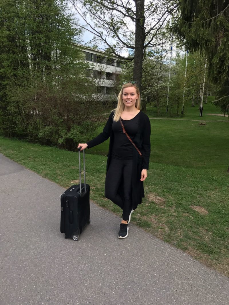 Helsinki Oulu Helsinki Annimarian A blonde girl in a black outfit with a samsonite suitcase