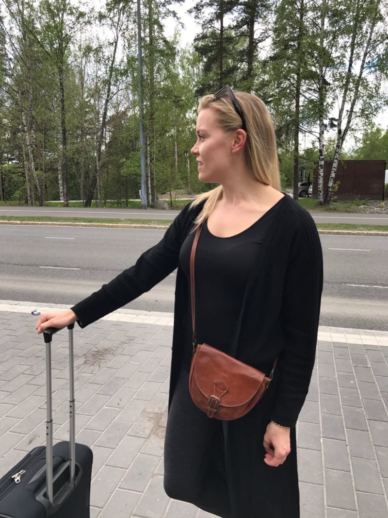 Helsinki Oulu Helsinki Annimarian A blonde girl in a black outfit with a samsonite suitcase