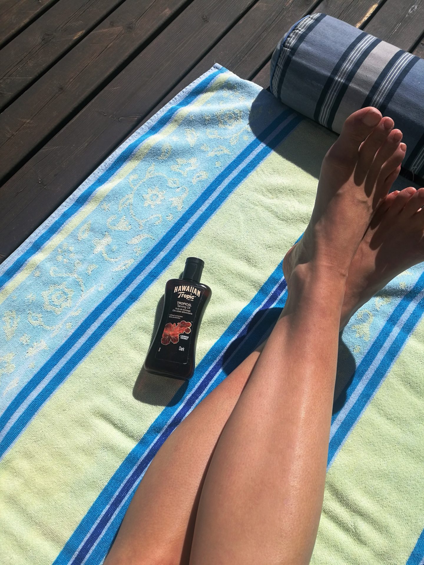 Finally warm Annimarian Colorful beach towel, tanned legs, Hawaiian tropic tanning oil