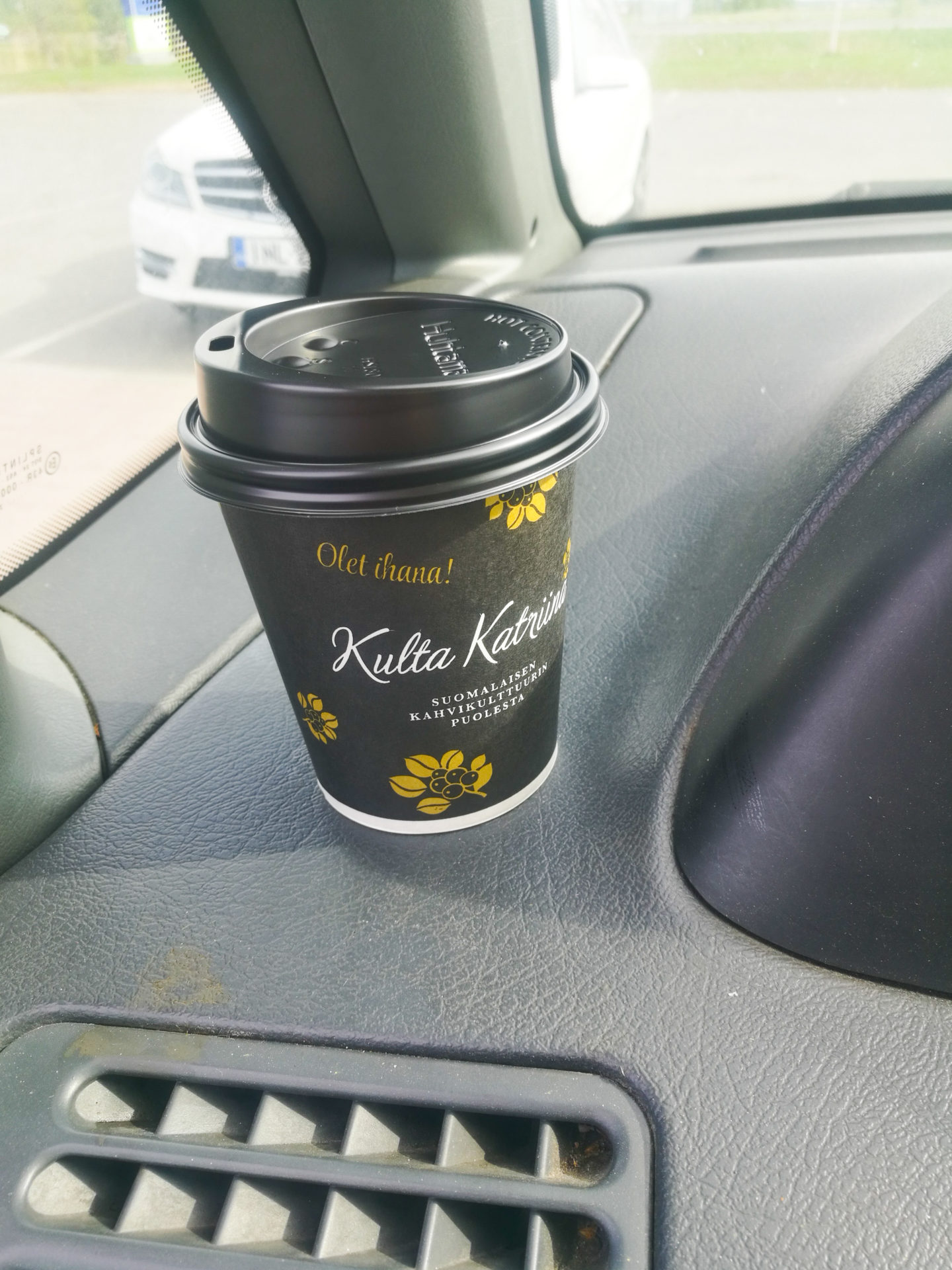 Weekend in pictures A Paulig take-away coffee cup on a dashboard of a car